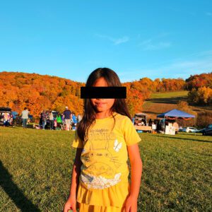 Image: Daughter with a picturesque fall landscape background